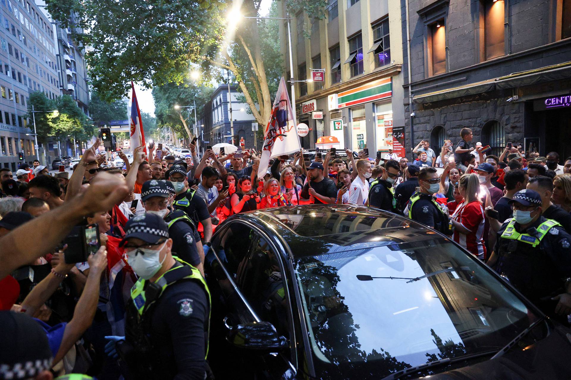 Supporters of Serbian tennis player Novak Djokovic rally in the street, in Melbourne