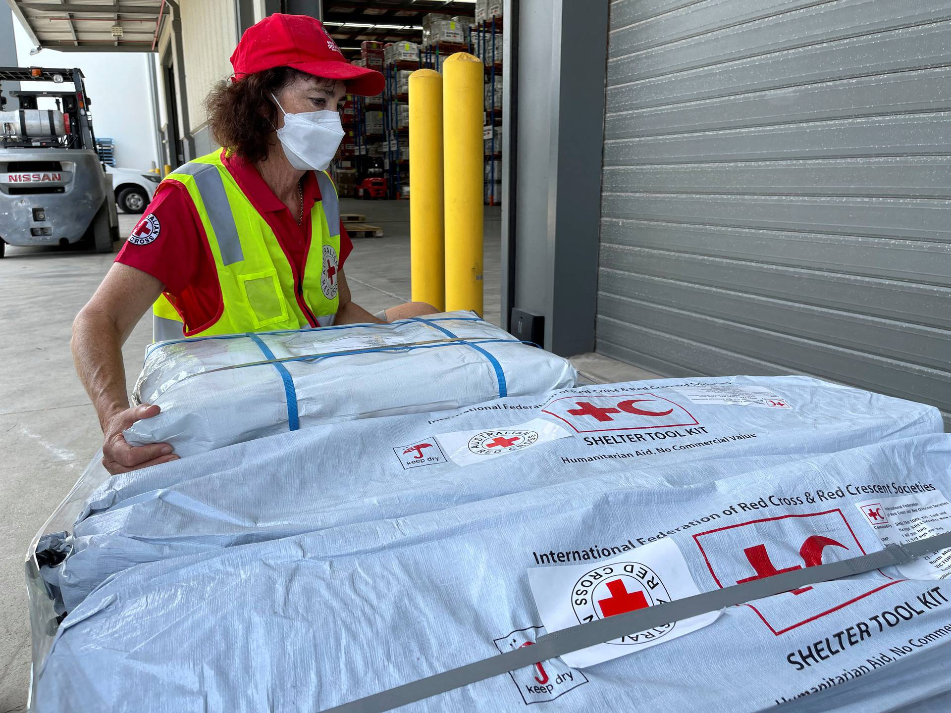 Supplies intended as relief material are prepared to be sent to Tonga by the Australian Red Cross, in Brisbane