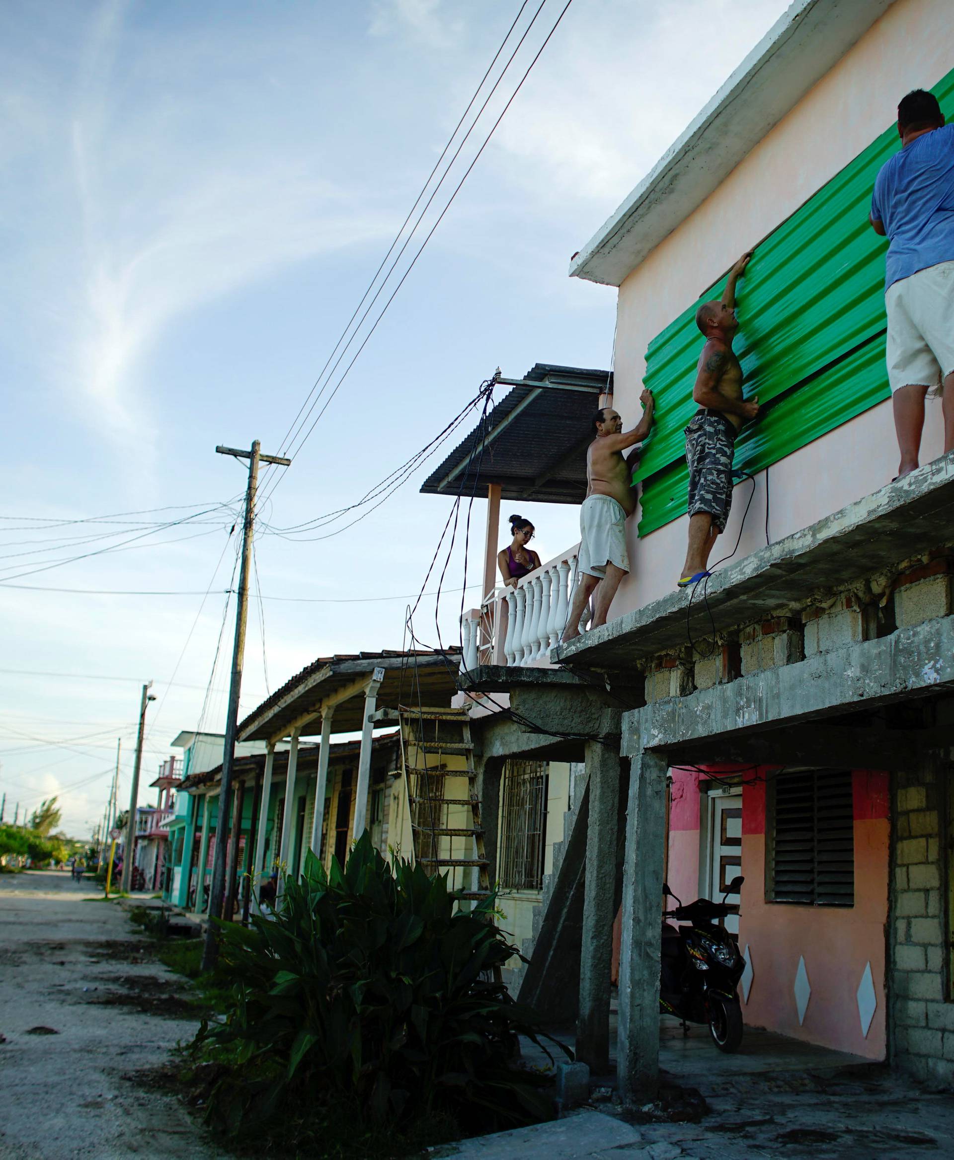 People protect the windows of a house prior to the arrival of the Hurricane Irma in Caibarien