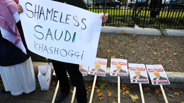 Placards can be seen outside the embassy as people protest against the killing of journalist Jamal Khashoggi in Turkey outside the Saudi Arabian Embassy in London
