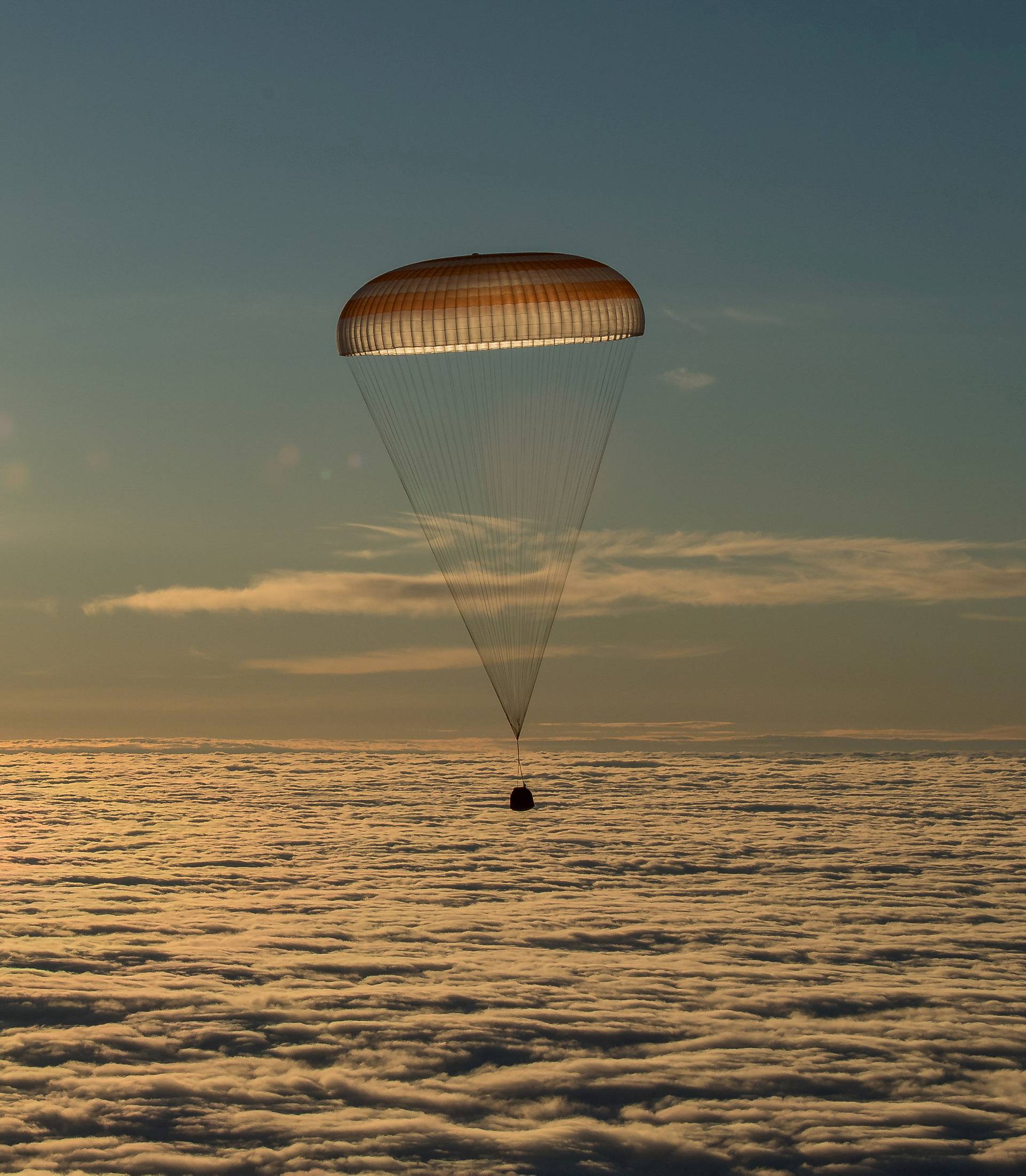 The Soyuz MS-06 capsule carrying the crew of Acaba and Vande Hei of the U.S., and Misurkin of Russia descends beneath a parachute just before landing in a remote area outside the town of Dzhezkazgan