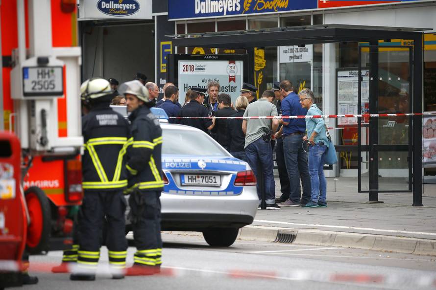Security forces are seen after a knife attack in a supermarket in Hamburg