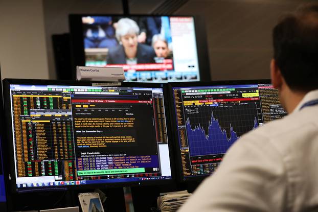 An investment manager, in the office of Aberdeen Standard Investments, watches Britain