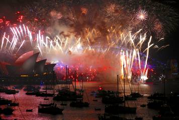 Fireworks light up the Sydney Harbour Bridge and Sydney Opera House during new year celebrations on Sydney Harbour