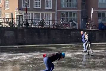 People skate on the frozen canal in Amsterdam