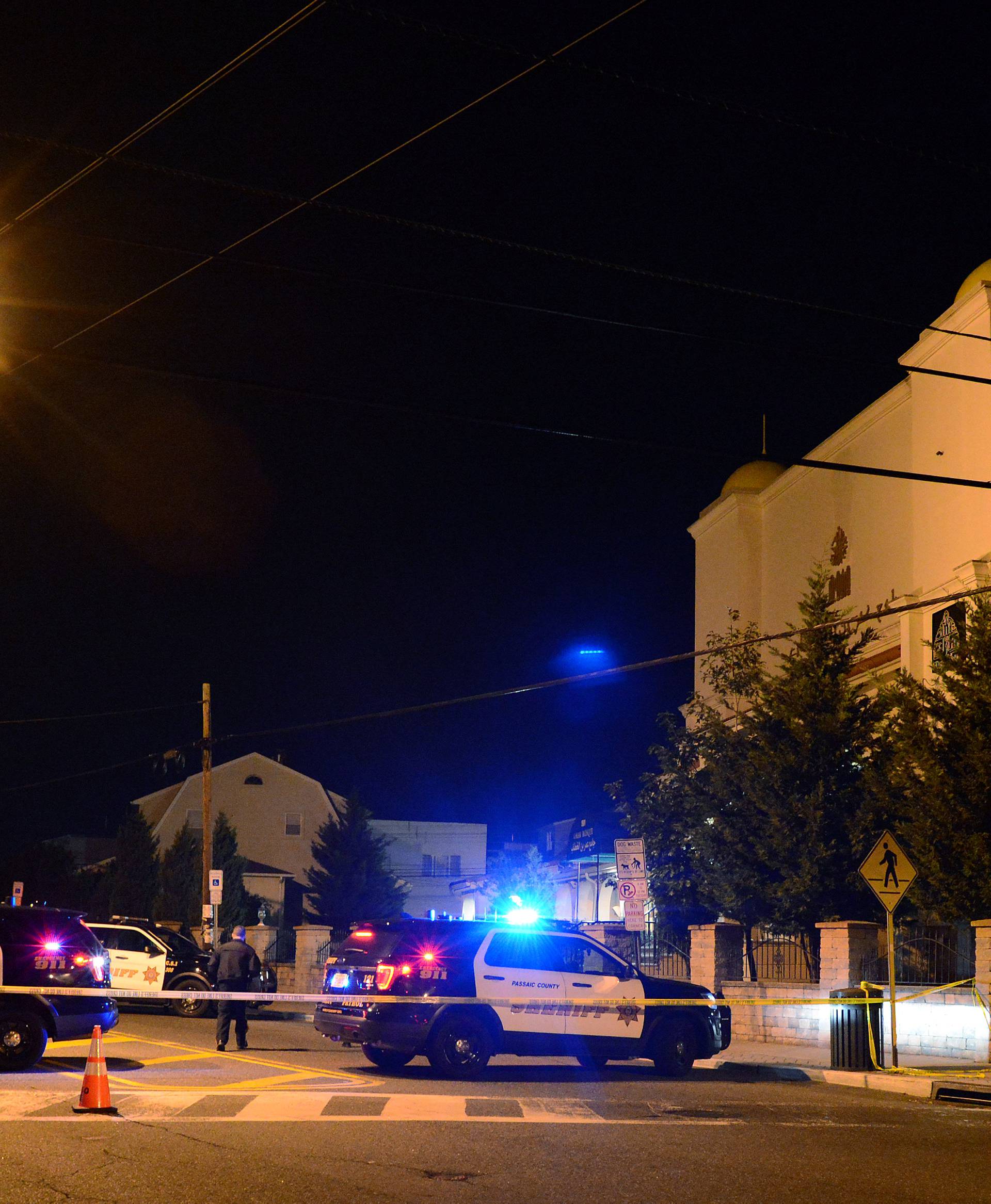 Patterson Police Department vehicles block off a street in front of a mosque in Patterson following the pickup truck attack in New York City