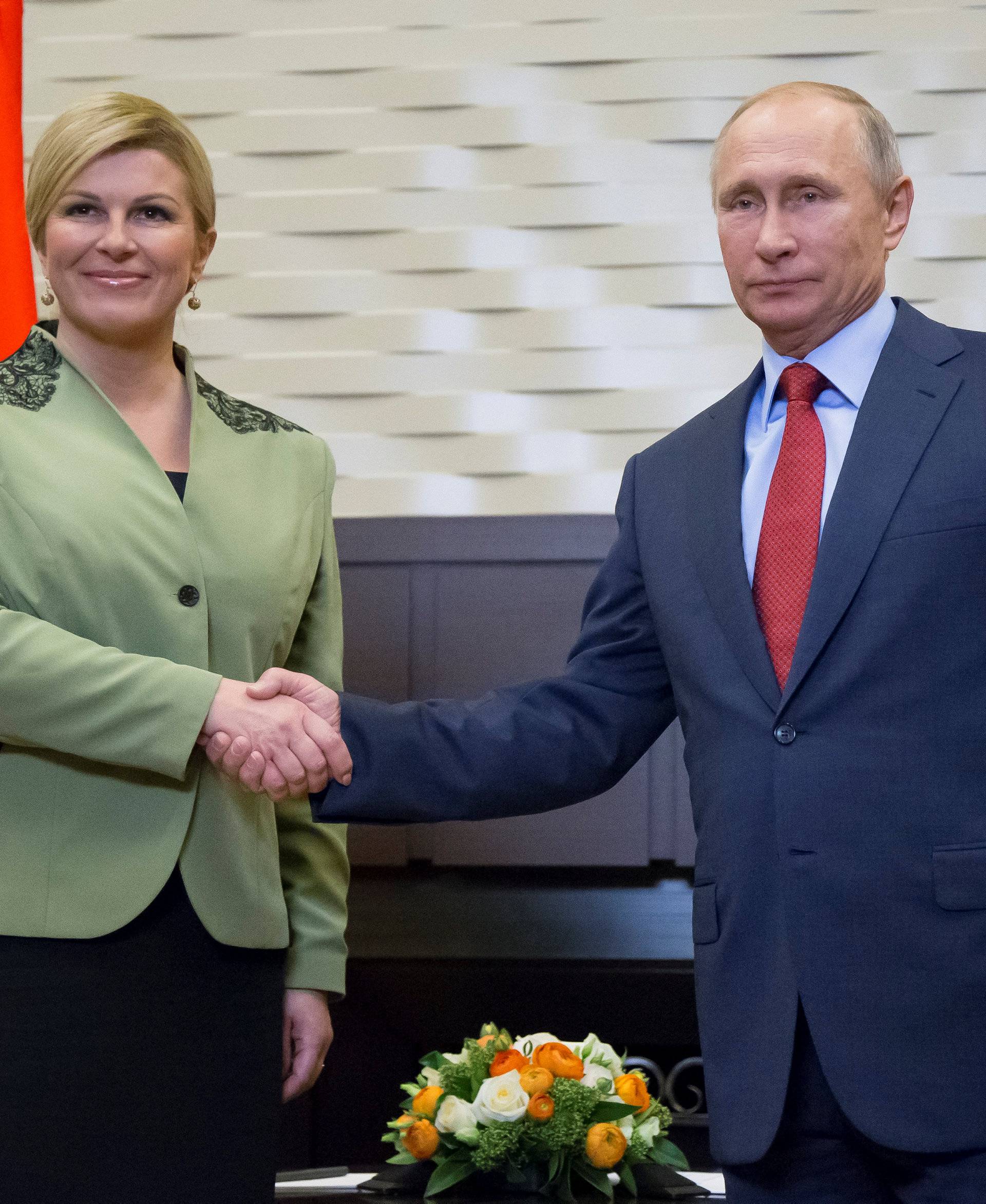 Putin shakes hands with Croatian President Kolinda Grabar-Kitarovic during their meeting in Sochi
