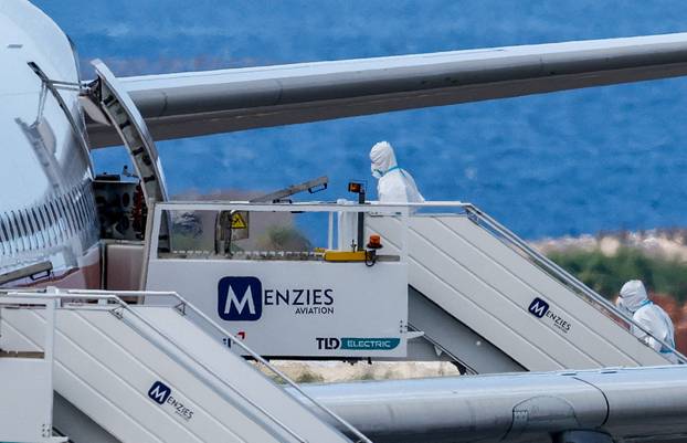 Passengers of the cruise ship MV Hondius, which was affected by a hantavirus outbreak, arrive at Tenerife Sud airport