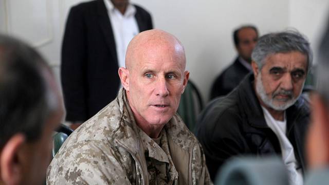 FILE PHOTO - Vice Adm. Robert S. Harward, commanding officer of Combined Joint Interagency Task Force 435, speaks to an Afghan official during his visit to Zaranj, Afghanistan, in this handout photo
