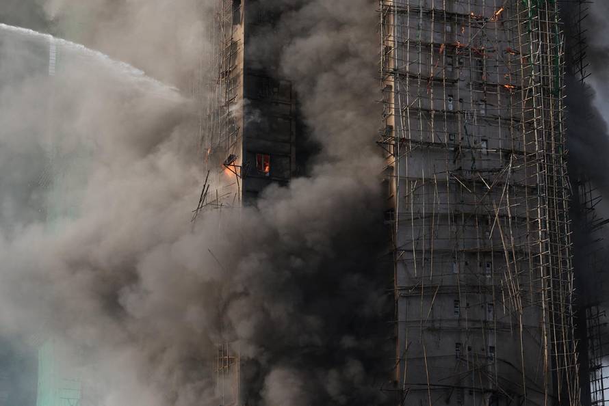 Flames engulf bamboo scaffolding across multiple buildings at Wang Fuk Court housing estate, in Tai Po
