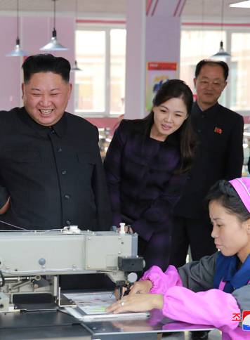 North Korean leader Kim Jong-Un and wife  Ri Sol Ju visit a shoe factory in this undated photo released by North Korea's Korean Central News Agency in Pyongyang
