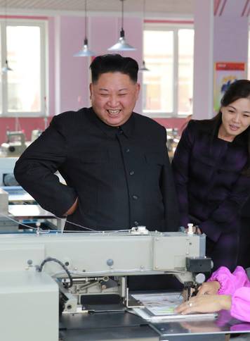 North Korean leader Kim Jong-Un and wife  Ri Sol Ju visit a shoe factory in this undated photo released by North Korea's Korean Central News Agency in Pyongyang