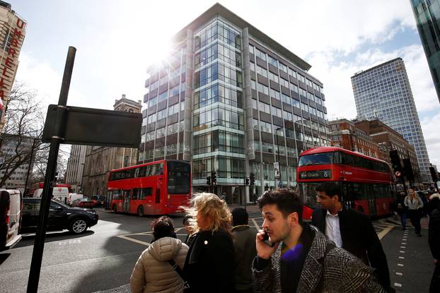 People walk past the building housing the offices of Cambridge Analytica in central London