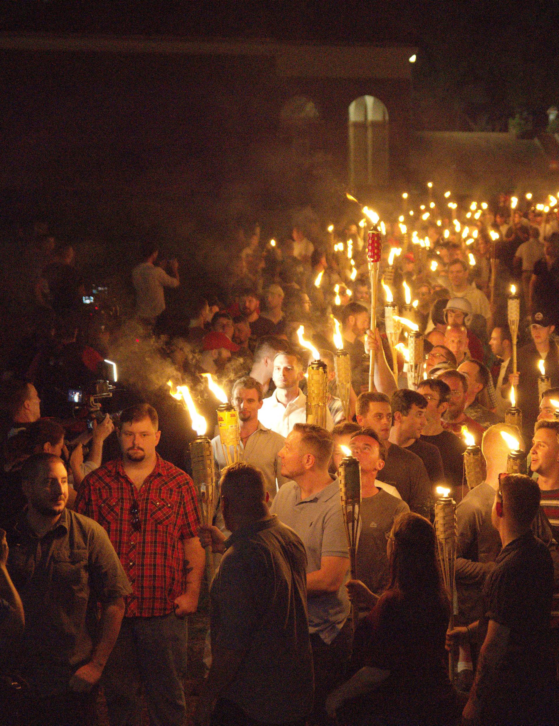 White nationalists carry torches on the grounds of the University of Virginia, on the eve of a planned Unite The Right rally in Charlottesville