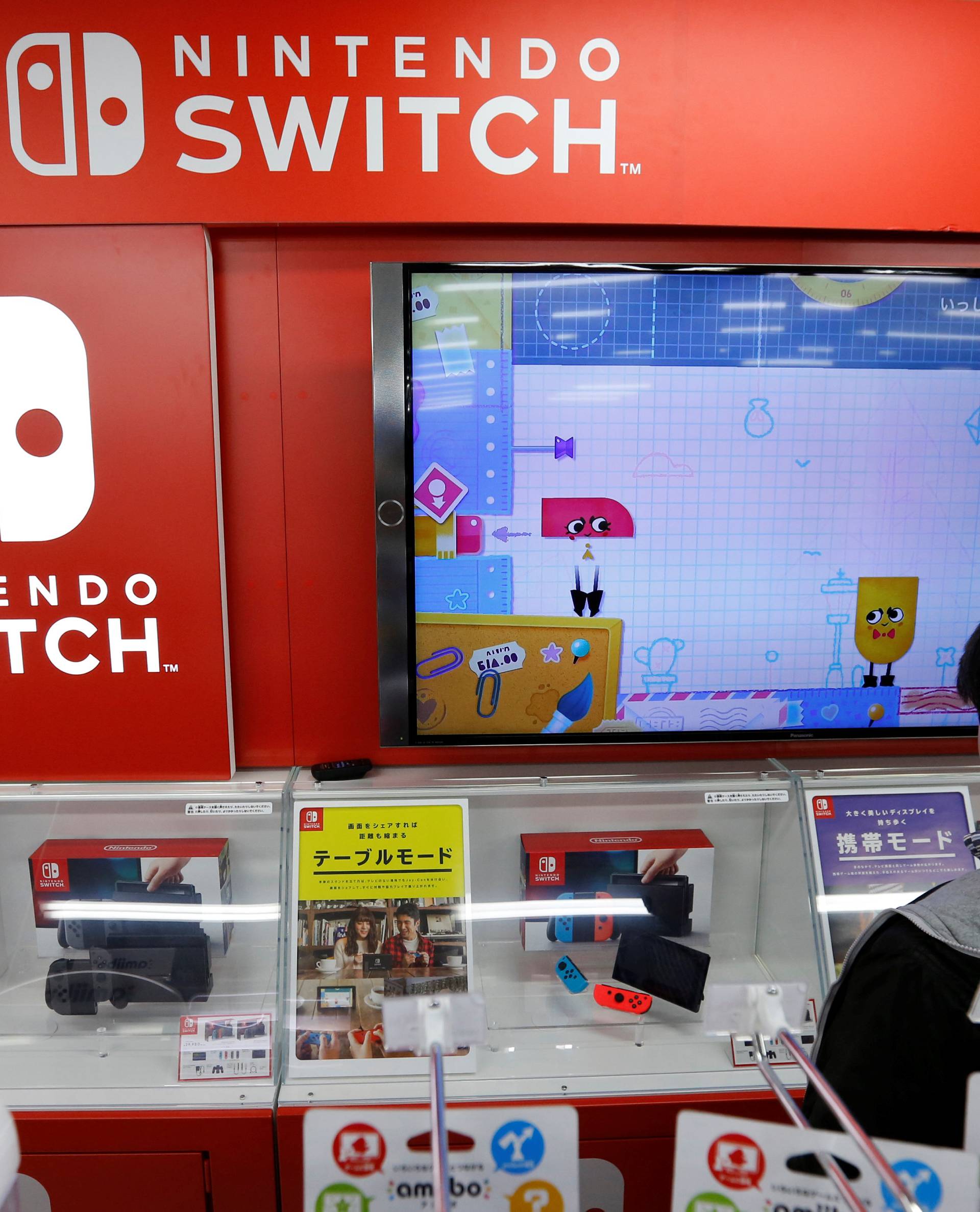 Logos of Nintendo Switch game console are seen at an electronics store in Tokyo