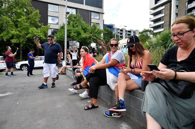 Supporters sit outside the Park Hotel, believed to be holding Serbian tennis player Novak Djokovic in Melbourne
