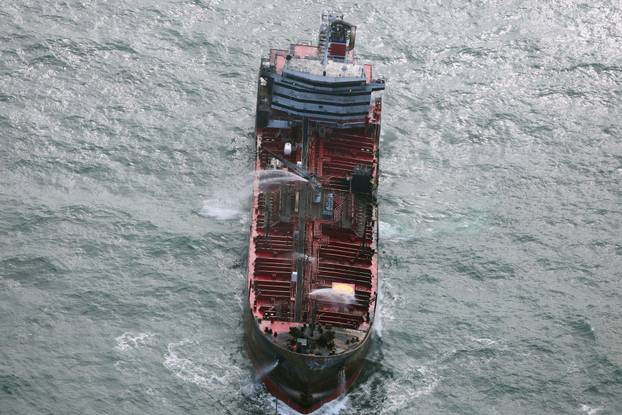 Aftermath of collision between container ship and oil tanker