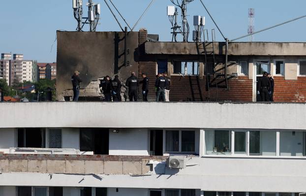 Law enforcement work on the site of an explosion at a residential block of flats following a drone hit in Galati