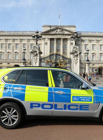 A police vehicle patrols outside Buckingham Palace in London