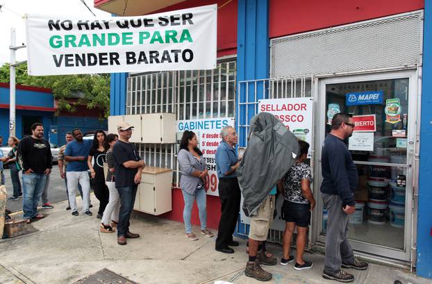 People stand in line outside a hardware store as they prepare for Hurricane Irma, in Bayamon