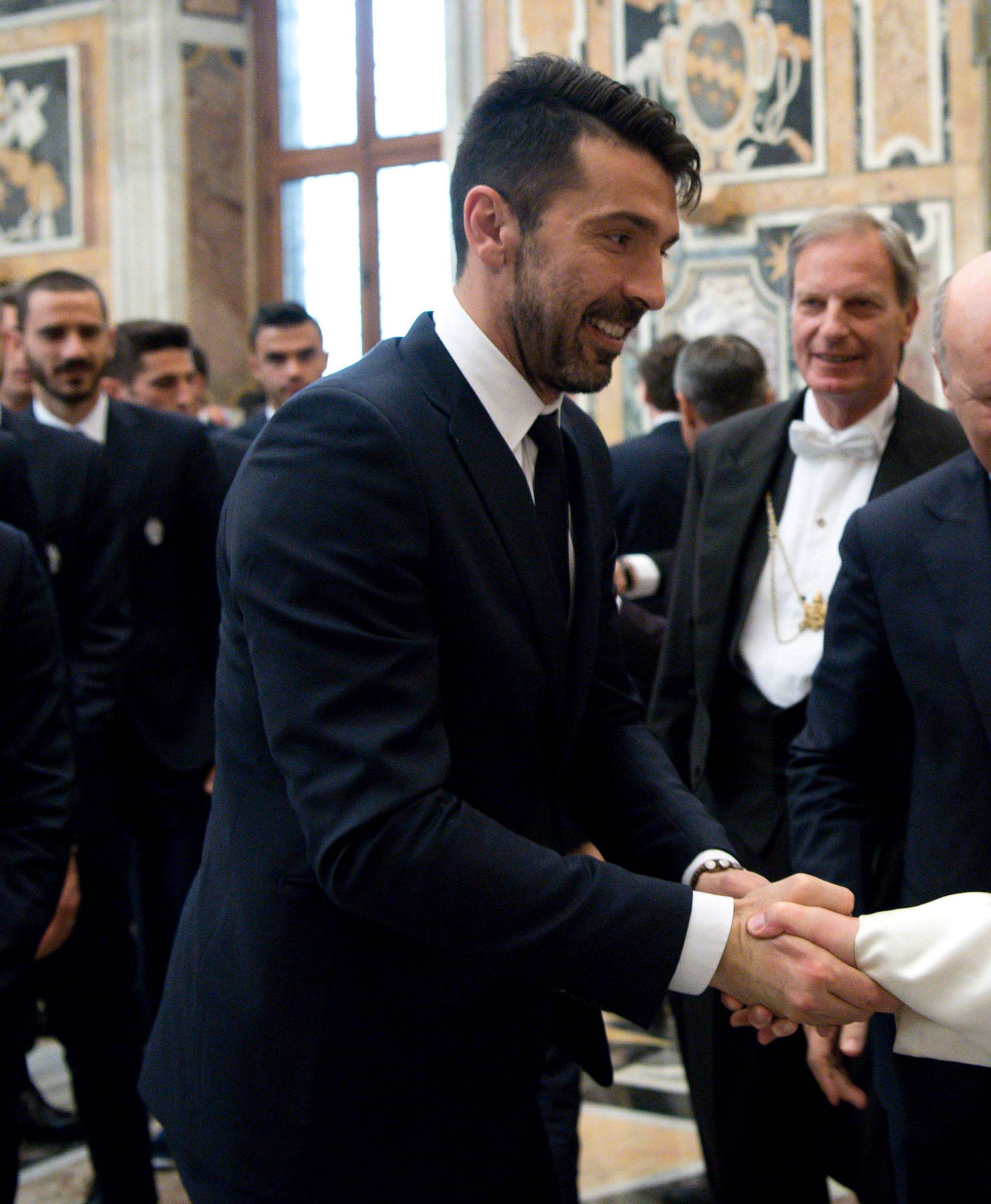 Juventus goalkeeper Gianluigi Buffon shakes hands with Pope Francis during a private audience at the Vatican