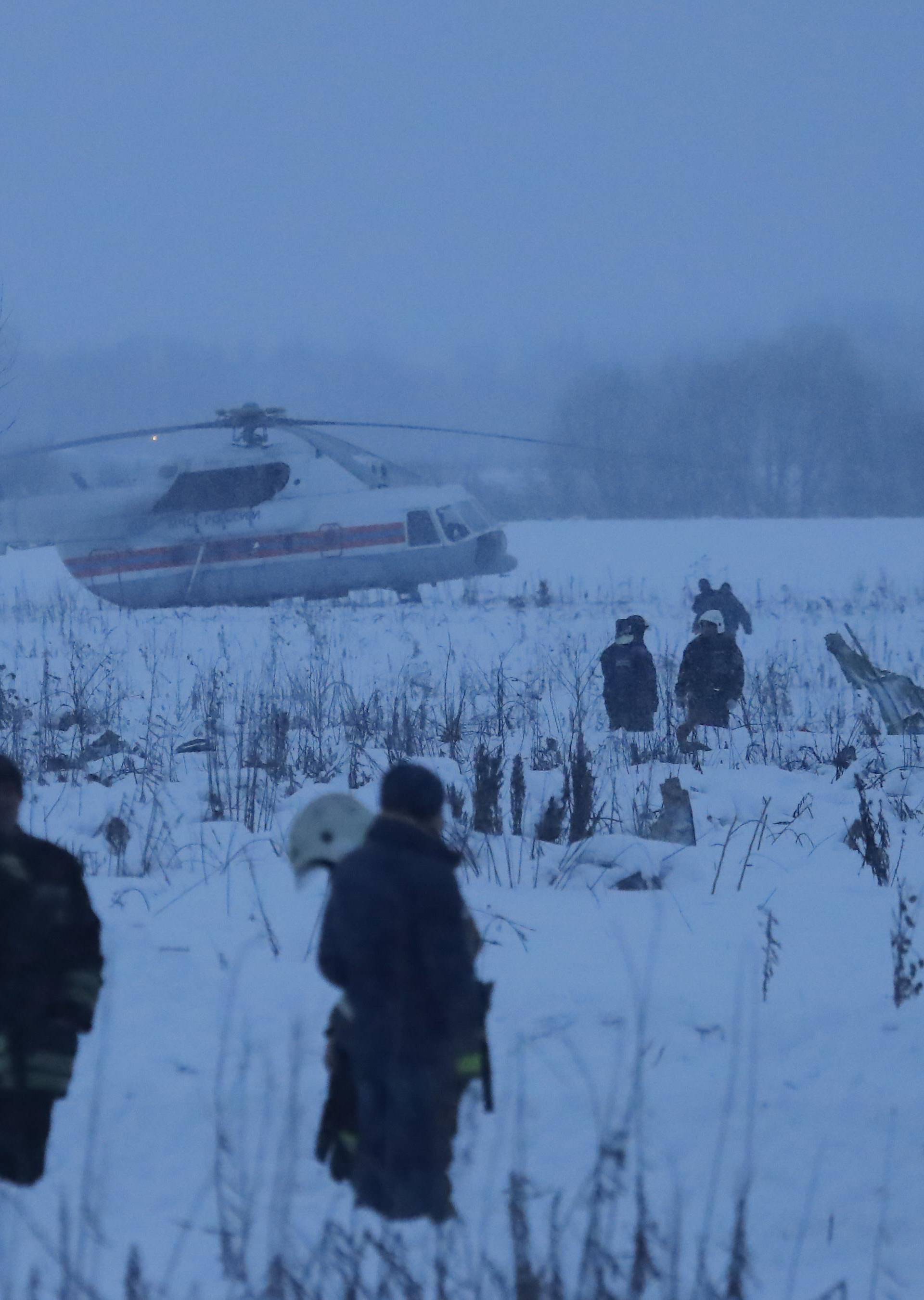 Emergency services work at the scene where a short-haul regional Antonov AN-148 plane crashed after taking off from Moscow's Domodedovo airport, outside Moscow