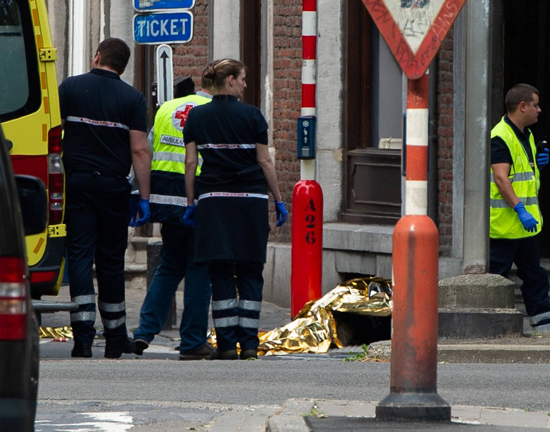 Rescuers are seen following a shooting in Liege