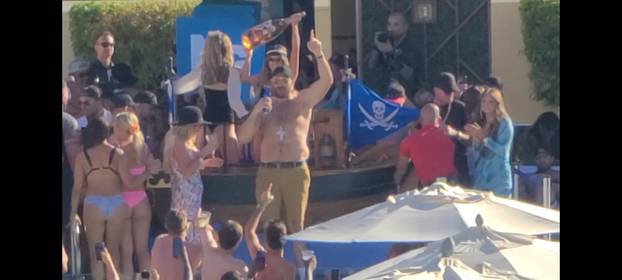 EXCLUSIVE: Tyson Fury parties shirtless as a fan dives into his vip pool as wife Paris and others celebrate his brutal world championship boxing win in Las Vegas