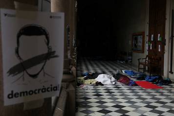 People sleep inside the University of Barcelona's historic building during a protest in favor of the banned October 1 independence referendum, in Barcelona