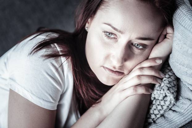Upset unsettled woman resting on pillow