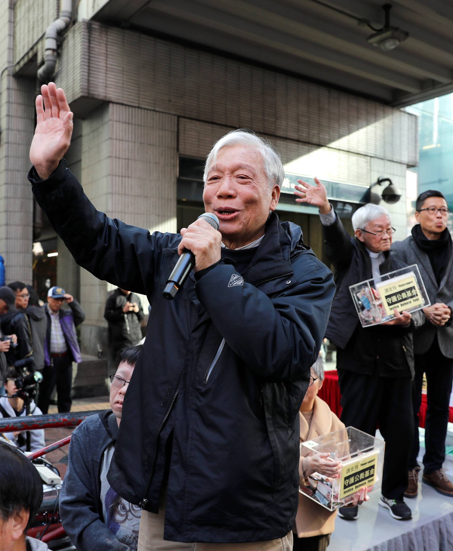 Occupy Central pro-democracy movement founder Chu Yiu-ming, waves to supporters as he takes part in an annual New Year's Day march in Hong Kong