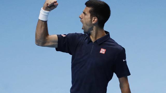 Serbia's Novak Djokovic celebrates winning the first set in his round robin match with Canada's Milos Raonic