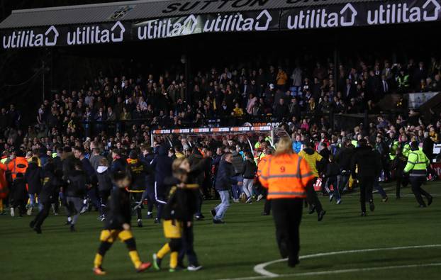 General view of Sutton fans on the pitch after the match