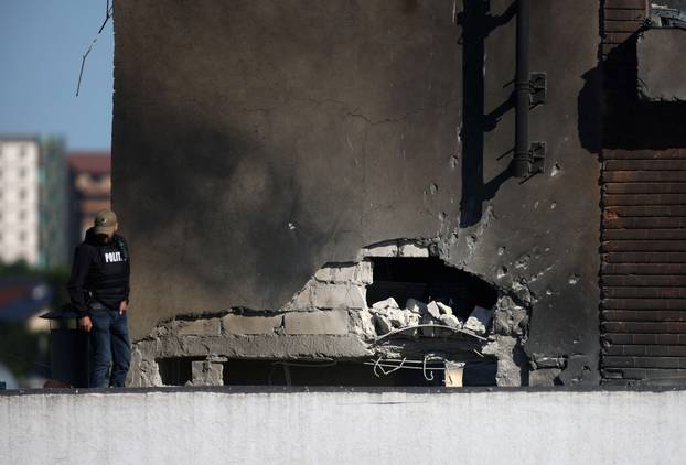 Law enforcement work on the site of an explosion at a residential block of flats following a drone hit in Galati