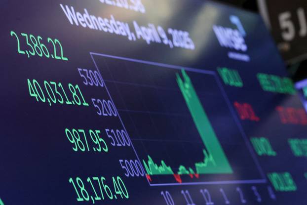 Traders work on the floor at the New York Stock Exchange, in New York City