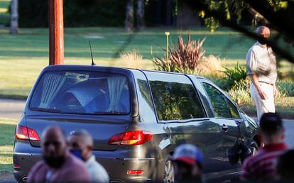 The car carrying the casket of soccer legend Diego Maradona arrives at the cemetery in Buenos Aires, Argentina