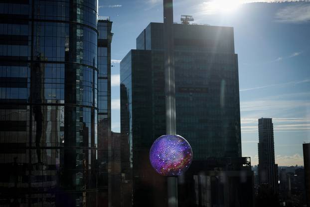 A newly created New Year's eve ball adorned with 5,280 Waterford crystals is raised for the first time above One Times Square ahead of the New Year's Eve ball drop in New York City