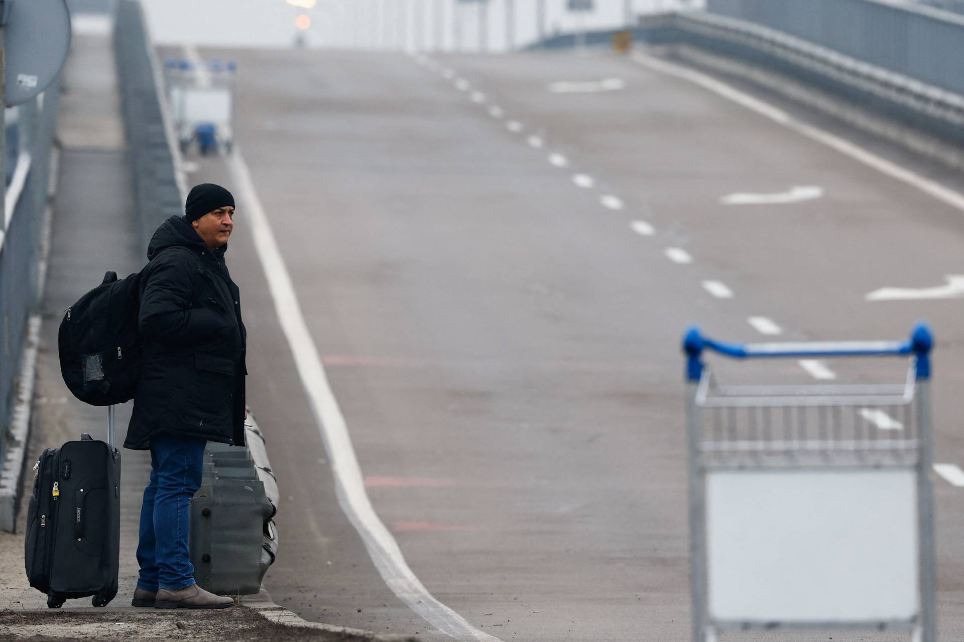 A person waits at Kyiv Airport after Russian President Vladimir Putin authorized a military operation in eastern Ukraine