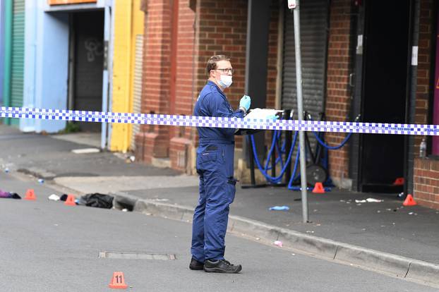 A Victoria Police personnel works at the scene of a multiple shooting outside Love Machine nightclub in Prahran, Melbourne