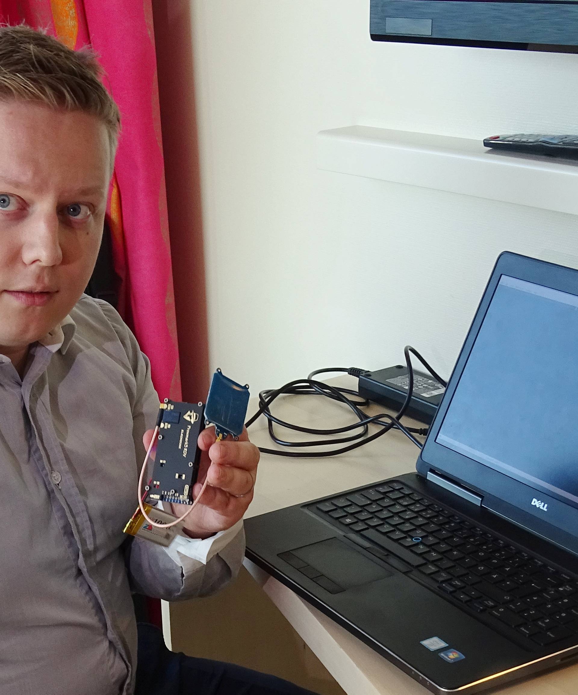 F-Secure researcher Hirvonen shows a device that is able to create a master key out of a single hotel key card in Helsinki