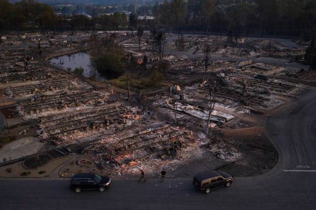 Security officials survey neighborhood left devastated by the Almeda fire in Phoenix, Oregon