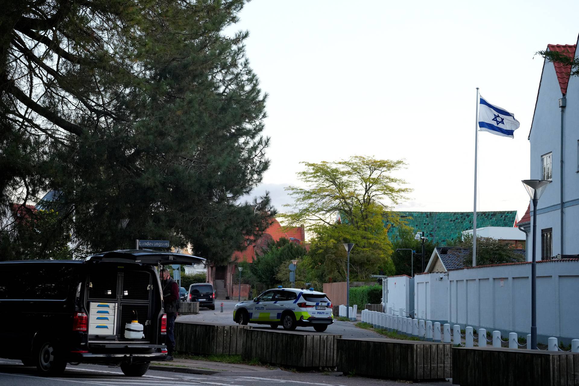 Police officers investigate two blasts near Israel's embassy in Copenhagen