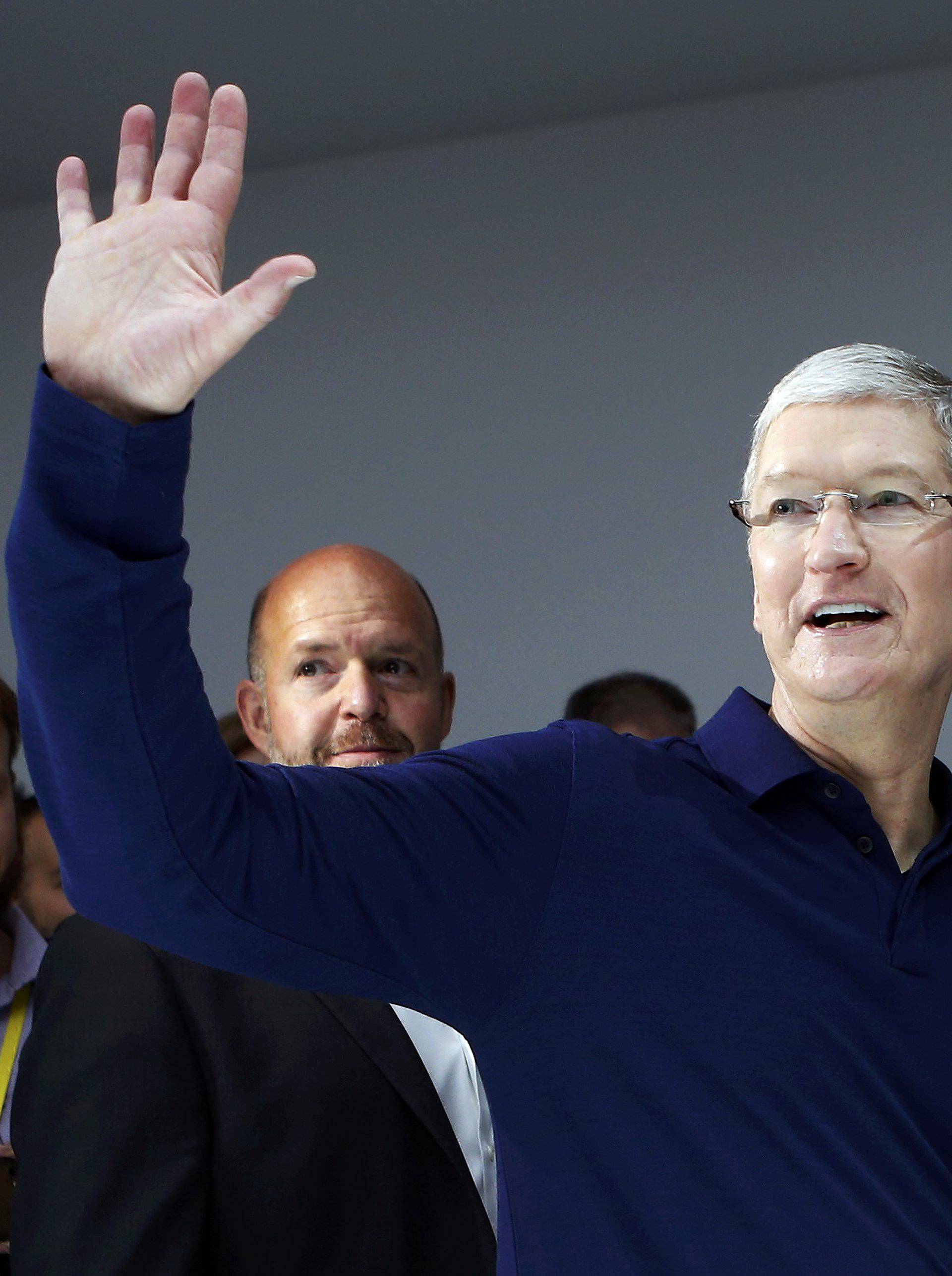 Tim Cook waves during an Apple media event in San Francisco