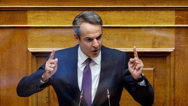 FILE PHOTO: Greek PM Mitsotakis addresses lawmakers during a parliamentary on a wiretapping case in Athens