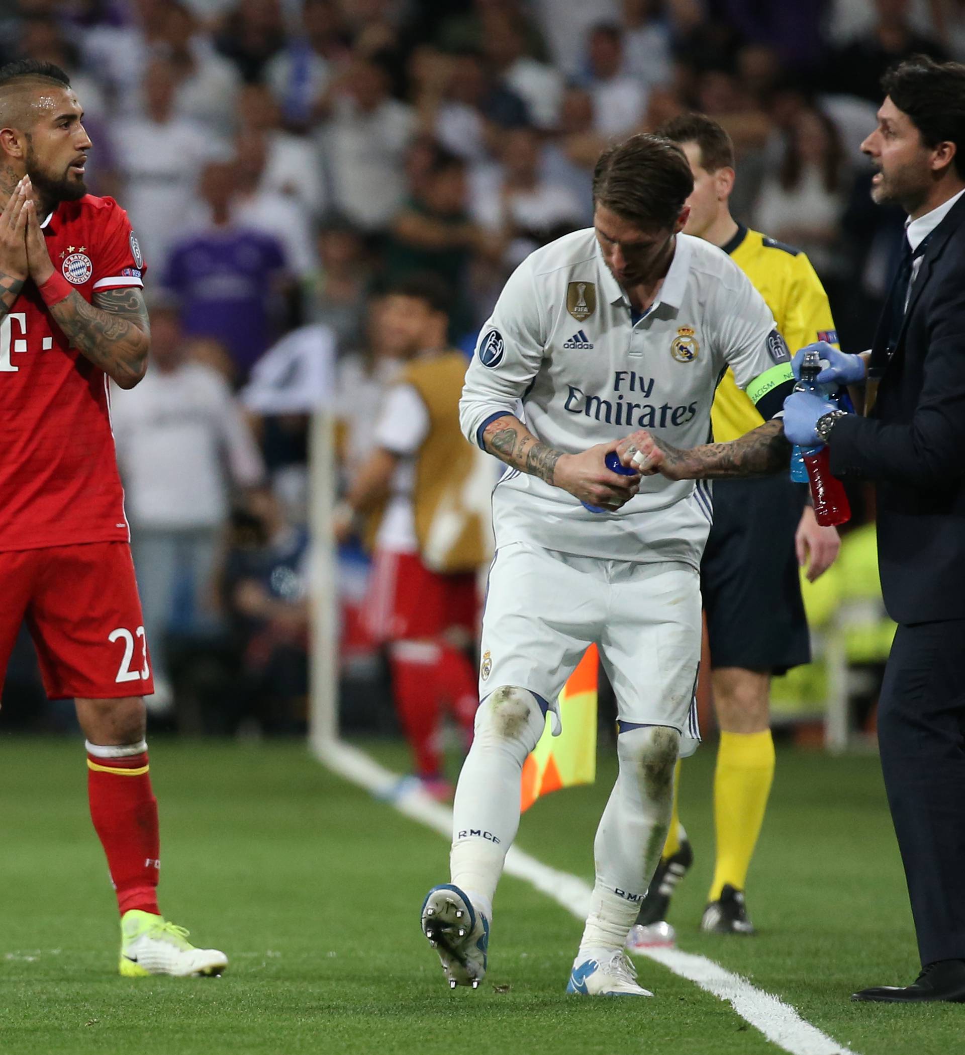 Bayern Munich's Arturo Vidal looks dejected after being sent off as Real Madrid's Sergio Ramos looks on