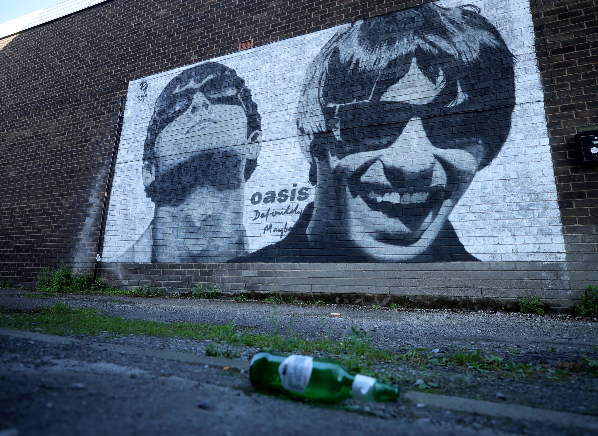 A view of a mural of Oasis band members Liam and Noel Gallagher by artist Pic.One.Art on the side of Sifters record shop in the Burnage area of Manchester