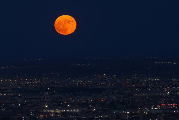 A super moon, known as the Blue Moon, rises above Ciudad Juarez