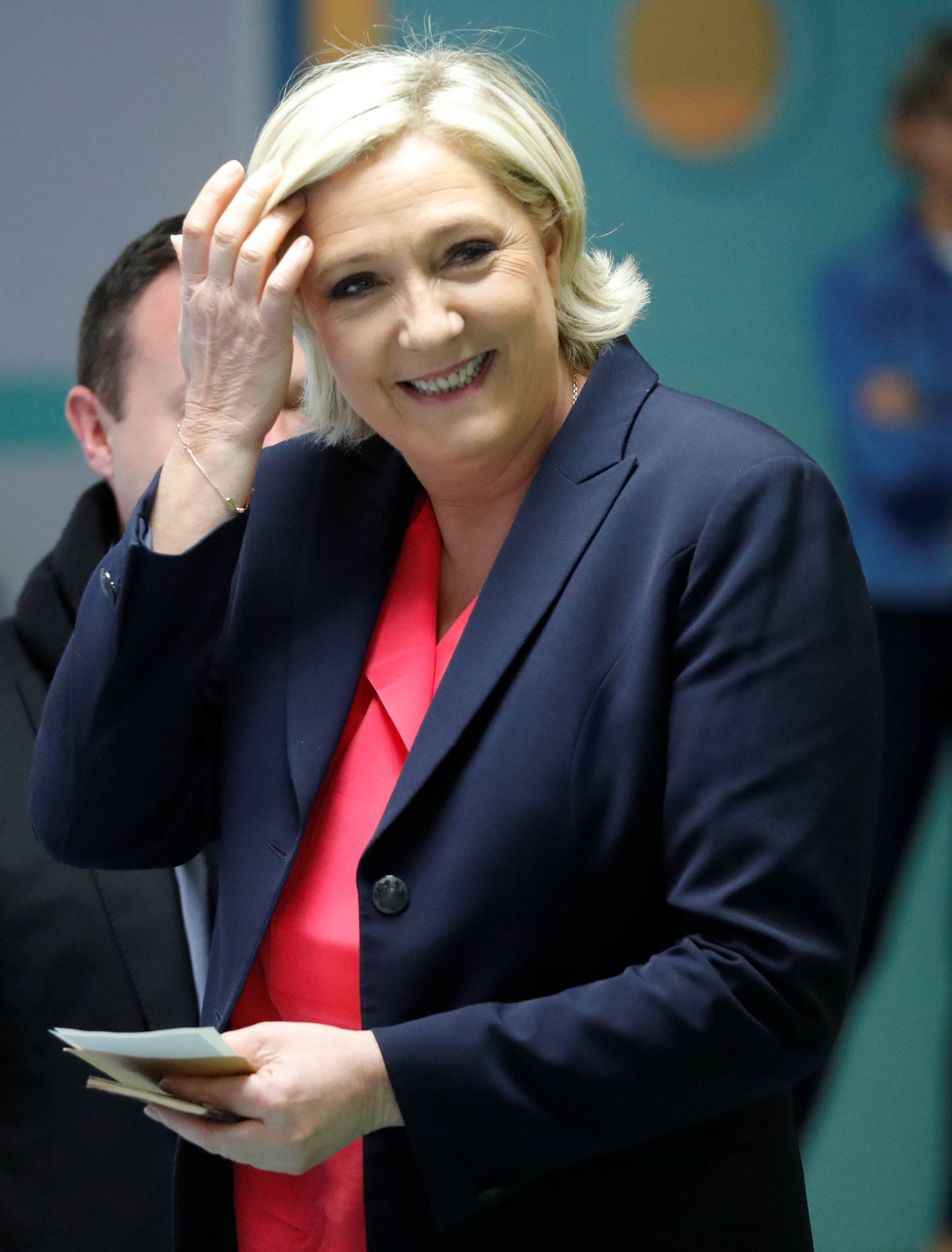 Marine Le Pen, French National Front political party candidate for French 2017 presidential election, smiles before voting in the second round of 2017 French presidential election at a polling station in Henin-Beaumont