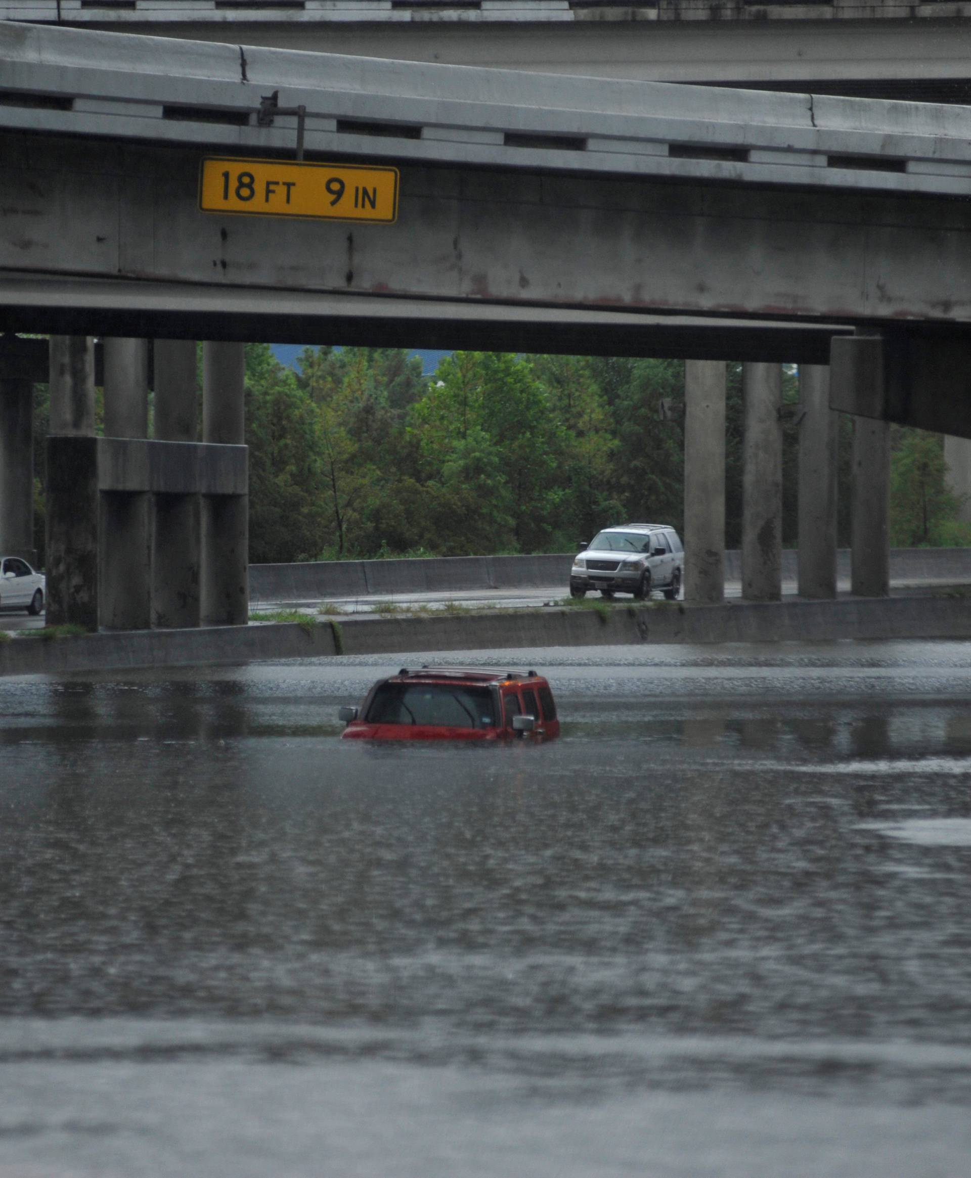 An abandoned Hummer is covered in floodwaters on Interstate 610 after Hurricane Harvey inundated the Texas Gulf coast with rain, in Houston