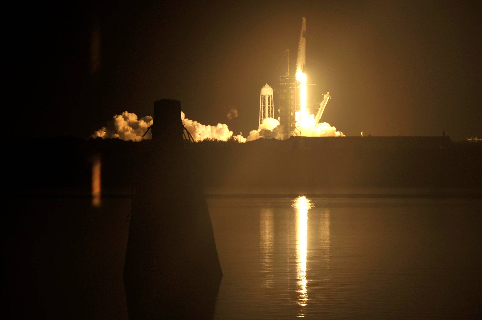 A SpaceX Falcon 9 rocket, topped with the Crew Dragon capsule carrying four astronauts on the first operational NASA commercial crew mission, launches at the Kennedy Space Center